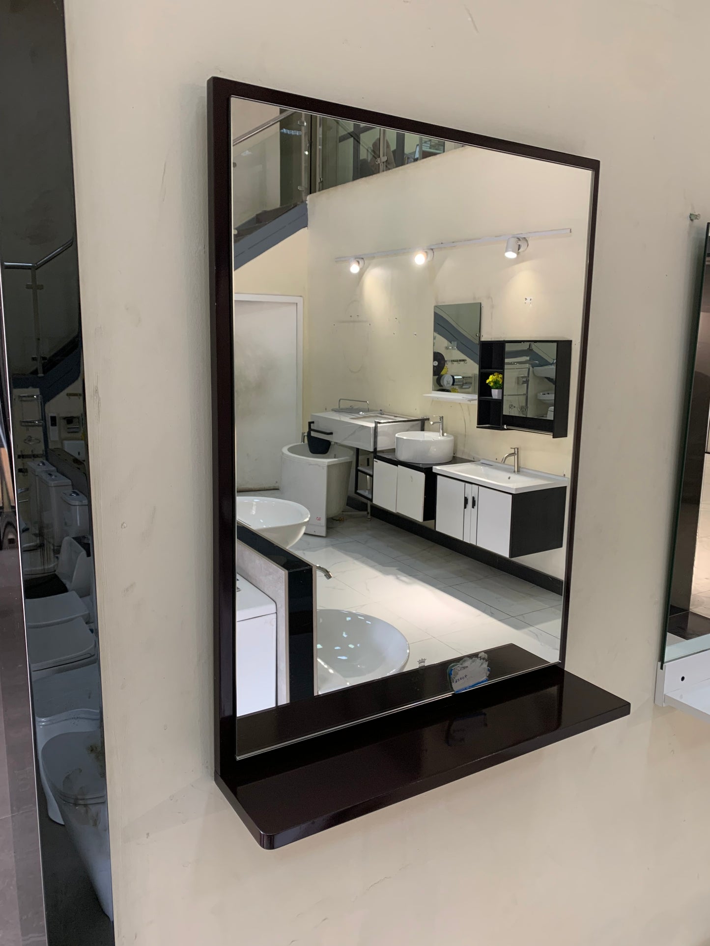 Wall-mounted mirror with a brown frame