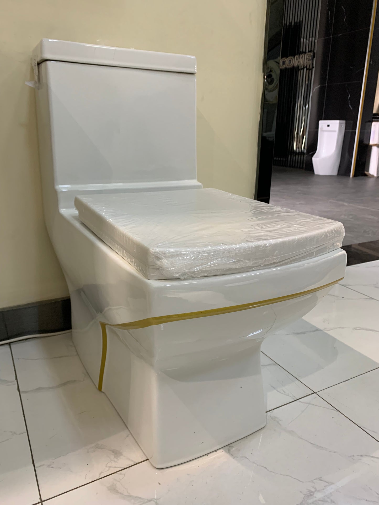 White & gold square shaped one piece toilets