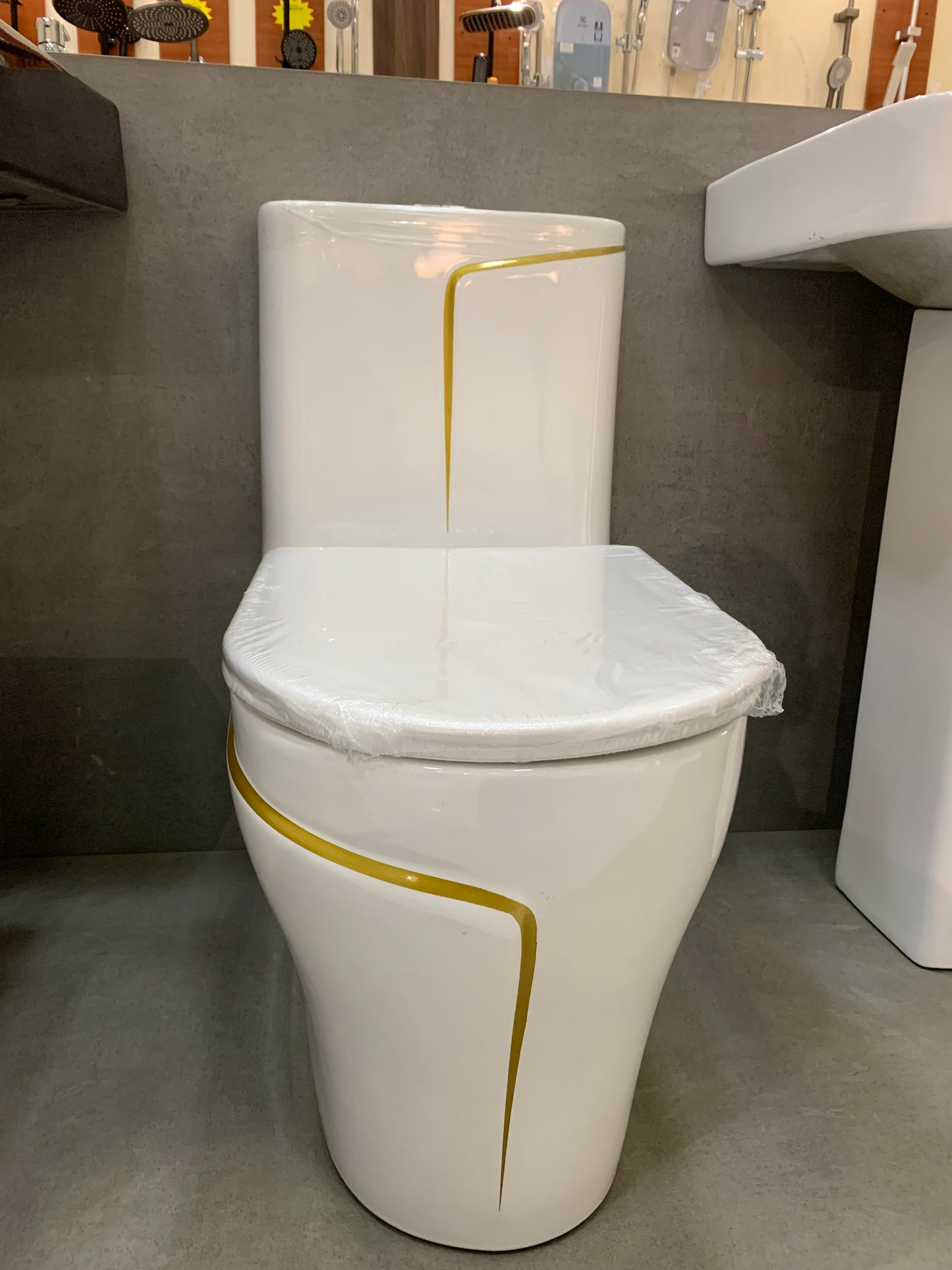 White and gold bowl shaped one piece toilet