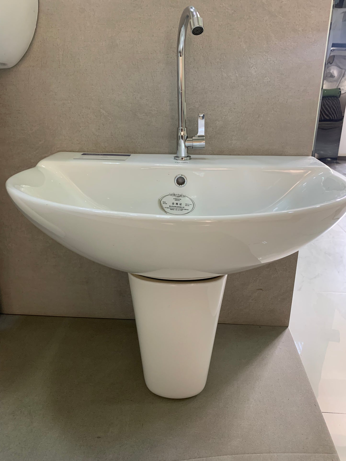 White wall hung basin with a pedestal